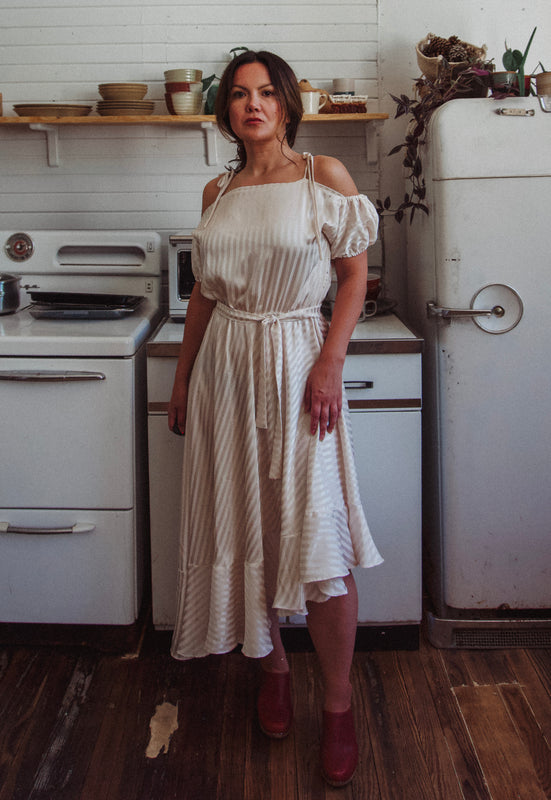 Christie Araujo Idylwild Vintage feminine Asymmetrical hem ruffle dress w off the shoulder puff sleeves