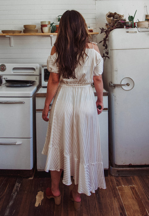 Christie Araujo Idylwild Vintage feminine Asymmetrical hem ruffle dress w off the shoulder puff sleeves