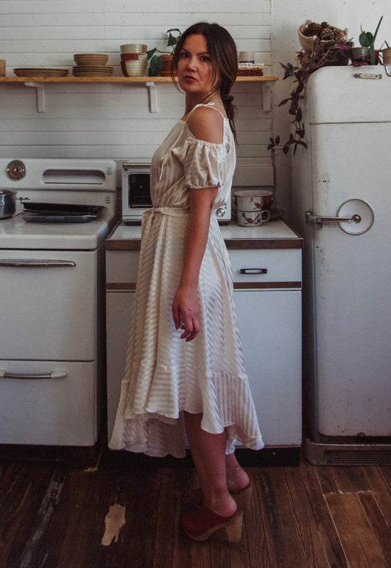 Christie Araujo Idylwild Vintage feminine Asymmetrical hem ruffle dress w off the shoulder puff sleeves