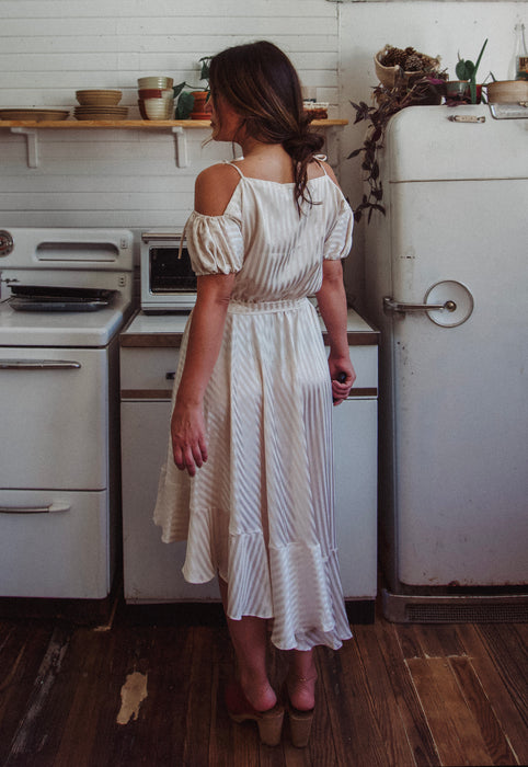 Christie Araujo Idylwild Vintage feminine Asymmetrical hem ruffle dress w off the shoulder puff sleeves