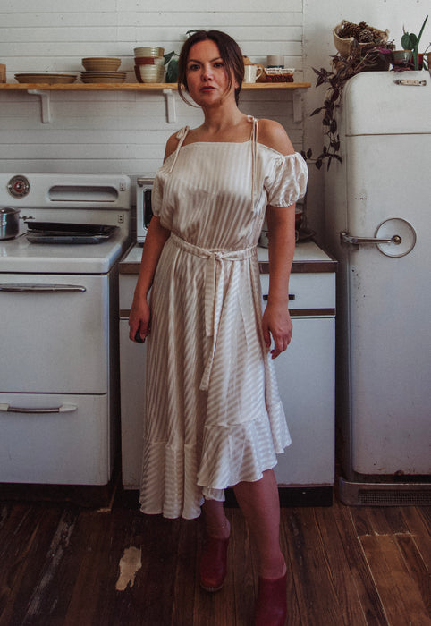 Christie Araujo Idylwild Vintage feminine Asymmetrical hem ruffle dress w off the shoulder puff sleeves