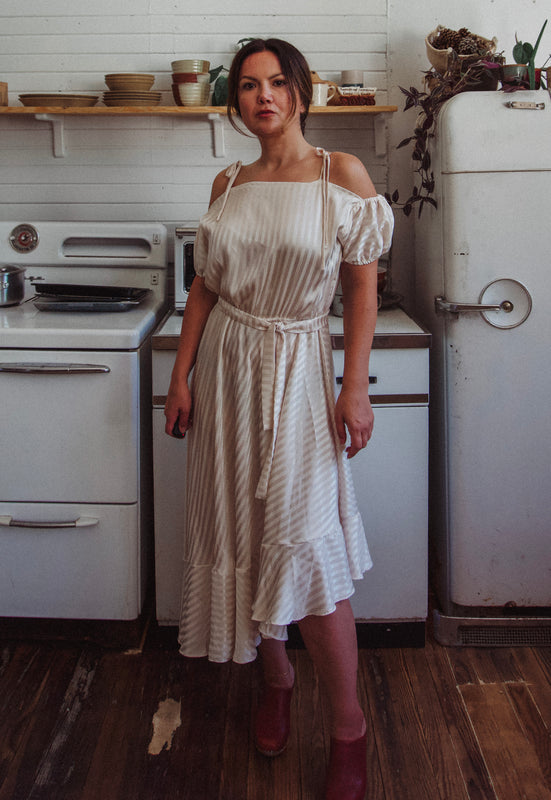 Christie Araujo Idylwild Vintage feminine Asymmetrical hem ruffle dress w off the shoulder puff sleeves