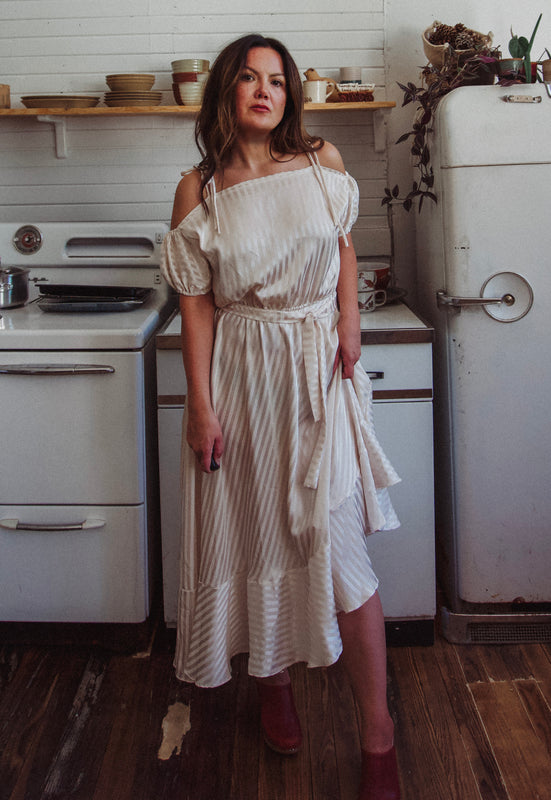 Christie Araujo Idylwild Vintage feminine Asymmetrical hem ruffle dress w off the shoulder puff sleeves