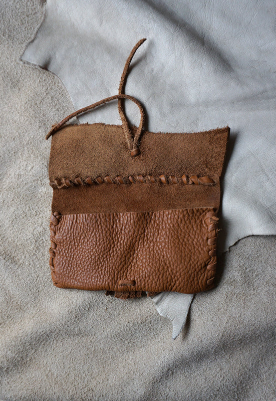 Handmade pebbled leather fringed clutch